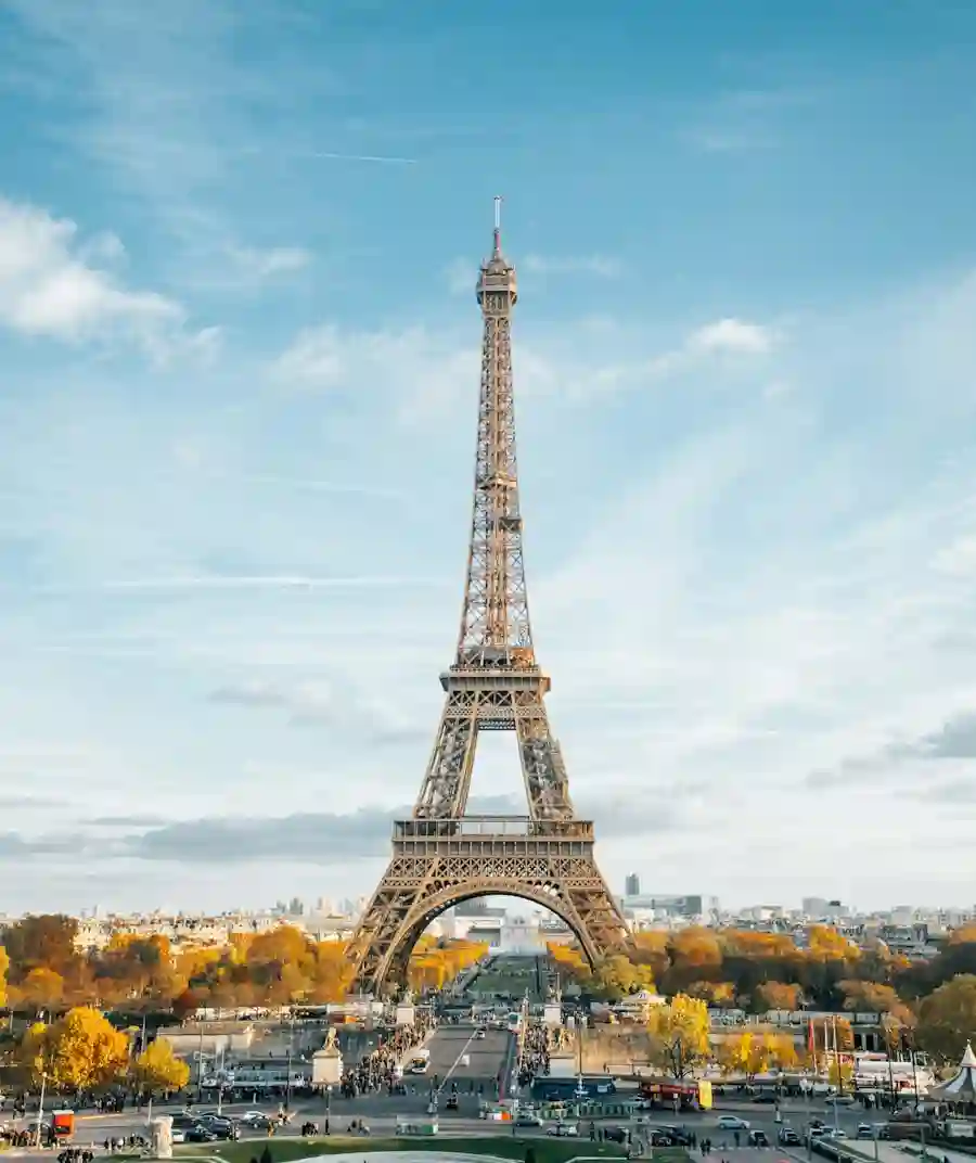 The Eiffel Tower rising against a bright blue sky on a sunny day